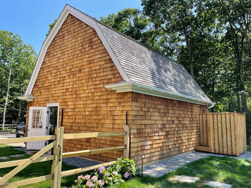 Handcrafted wooden shed with cedar shingles and durable roofing, ideal for storage or outdoor workspace in Suffolk County, NY