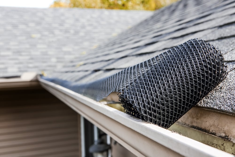 Roll Of Plastic Mesh Guard Over Gutter On A Roof in Suffolk County, NY