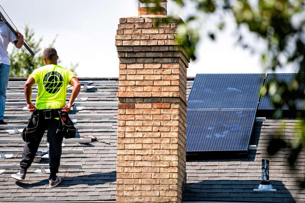 Two workers installing skylights on a rooftop in Suffolk County, NY